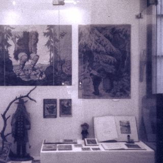 Vintage art exhibition featuring prints, sculptures, and natural elements.