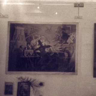 Two vintage paintings on a wall.
