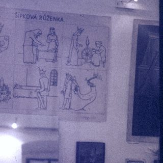 Traditional Czech Christmas pyramid display with nativity scene illustrations.