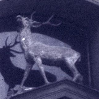 Facade of building with deer relief sculpture and number 273.