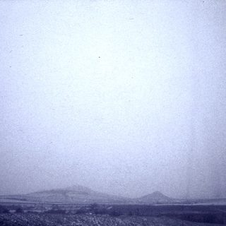 Foggy landscape with distant hills.