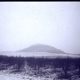 Snow-covered hill in winter landscape.