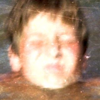 Person swimming underwater holding a ball.