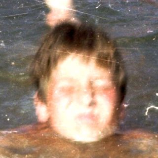 Person swimming underwater holding a ball.