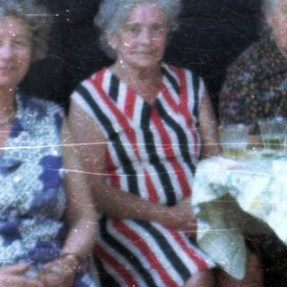 Group of elderly people gathered indoors for a meal.