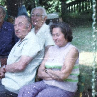 Group of people gathered outdoors for a meal.