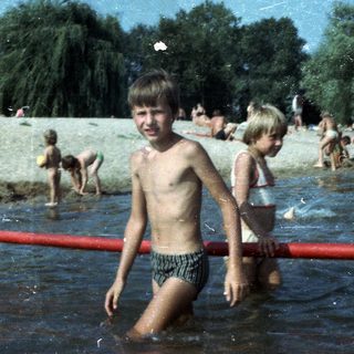 Shallow water beach with children playing.