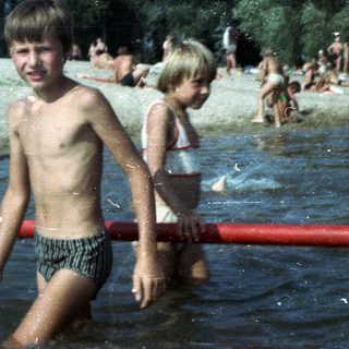 Shallow water beach with children playing.