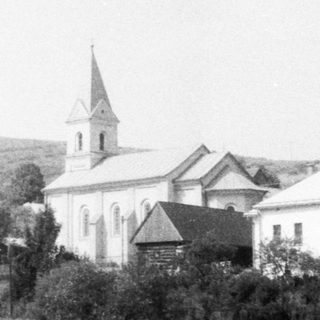 Rural village scene with church and houses.