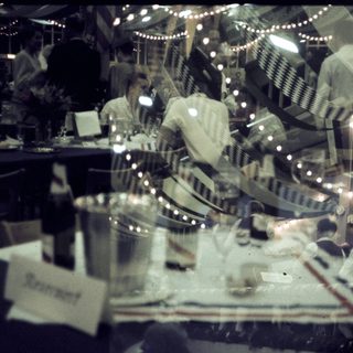 Busy restaurant kitchen with chefs preparing food.