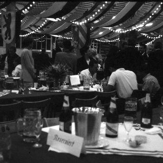 Indoor market restaurant with busy tables and string lights.
