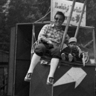 Classic carousel with seated riders enjoying a vintage amusement ride.