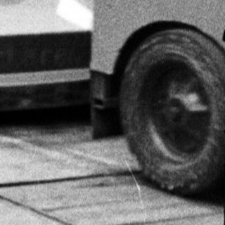 Miniature race cars on indoor track.