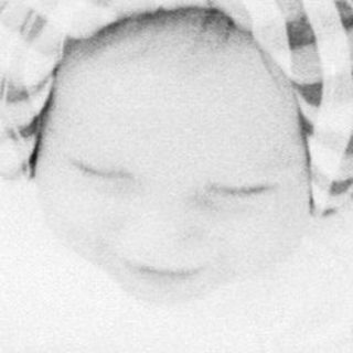 Baby sleeping peacefully in a stroller.