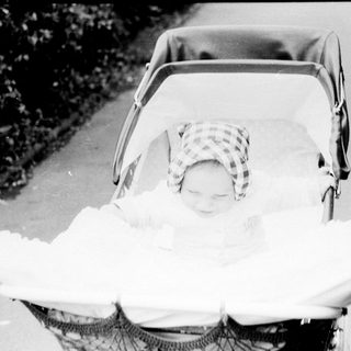 Baby sleeping peacefully in a stroller.