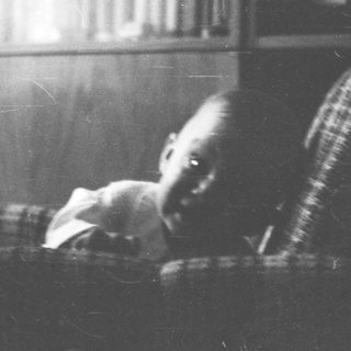 A child sleeping on a couch indoors.