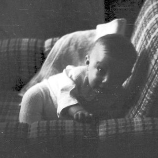 A person sleeping peacefully on a bed.