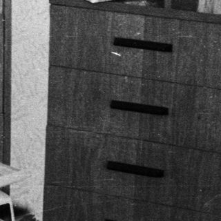 Young child playing with vintage electronic toys.