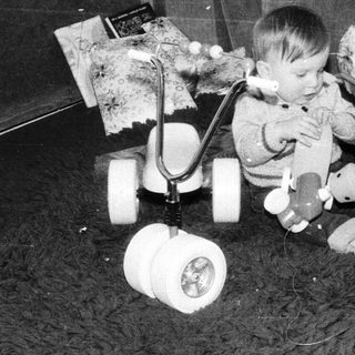 Young child playing with vintage electronic toys.