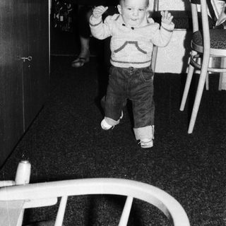 Young child taking first independent steps indoors.