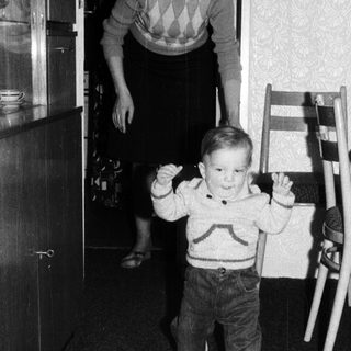 Young child taking first independent steps indoors.