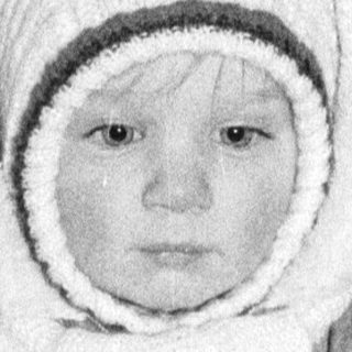 Young child dressed warmly in winter attire.