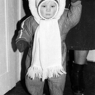 Young child dressed warmly in winter attire.