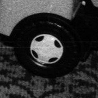 Baby learning to walk with push toy.