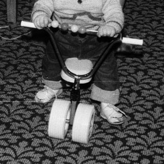 Baby learning to walk with push toy.