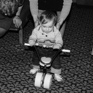 Baby learning to walk with push toy.