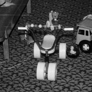 Child playing with toy vehicles indoors.
