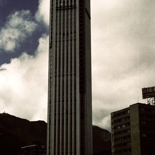 Tall modern skyscraper in urban setting.