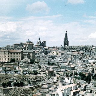 Historic cityscape with prominent cathedral and old architecture.