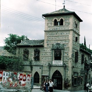 Historic stone building with antique shop entrance.