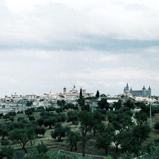 Historic cityscape with royal palace and greenery.