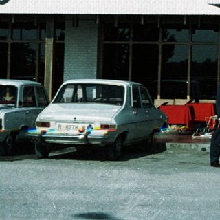 Mid-century hotel entrance with two men standing outside.