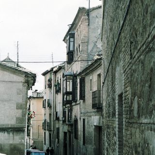 Narrow cobblestone street with old buildings.