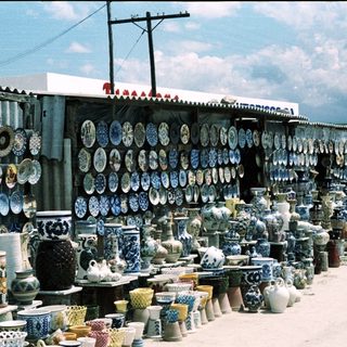 Colorful ceramic pottery and dishes displayed outdoors.