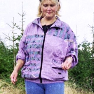Person hiking through dry, grassy terrain.