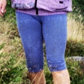 Person hiking through dry, grassy terrain.