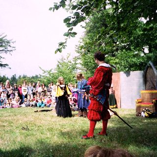 Medieval reenactment performance with costumed actors.