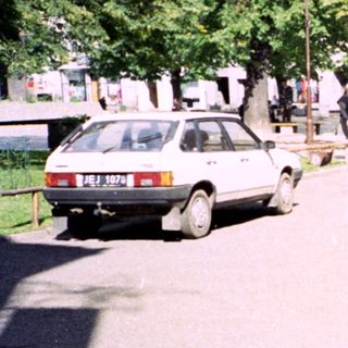 Young man walking outdoors in urban area.