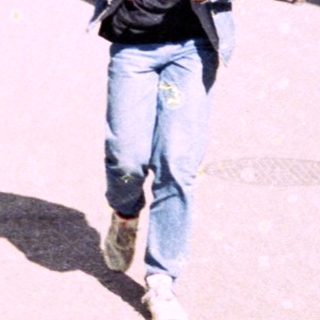 Young man walking outdoors in urban area.