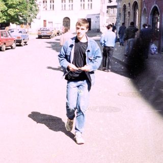 Young man walking outdoors in urban area.