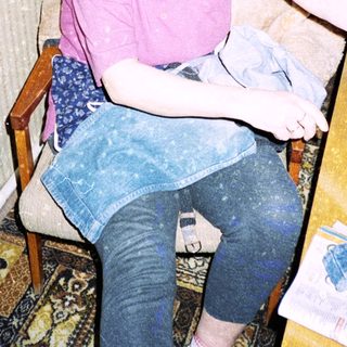 Person sewing or mending clothes indoors.
