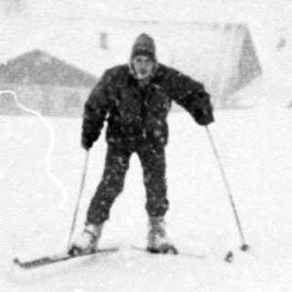 Skiing in heavy snowfall on a slope.