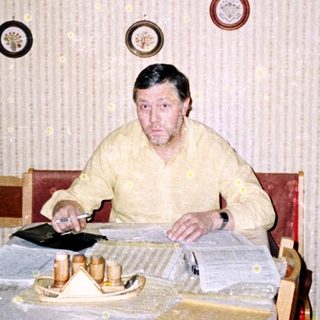 Man sitting at a table with papers.