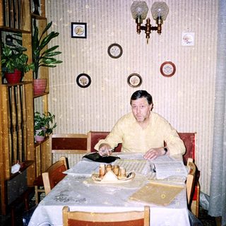 Man sitting at a table with papers.