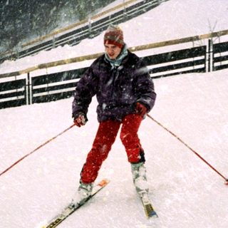 Person skiing in heavy snowfall on mountain trail.