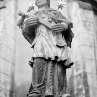 Statue of saint holding child with stars.